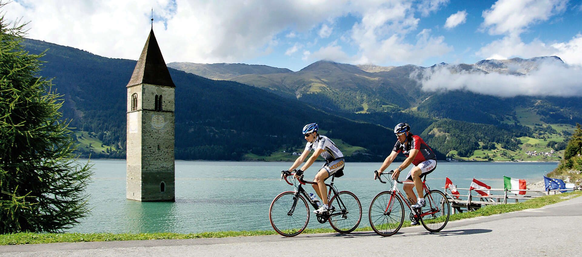  Cyclists on racing bikes on the ride around Lake Reschen, Tyrol